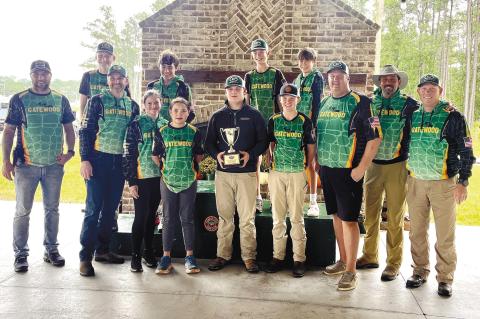 The coaches and student-athletes of Gatewood’s middle school shotgun team pose with the winning hardware Oct. 13, after securing their fourth-consecutive state championship at the GIAA Middle School Shotgun Invitational in Savannah. CONTRIBUTED