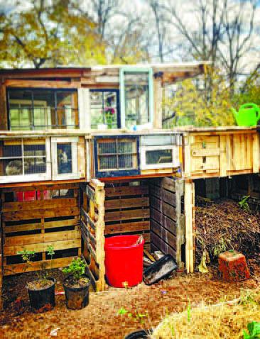 Three bin compost pile setup with rabbit hutches on top. CONTRIBUTED