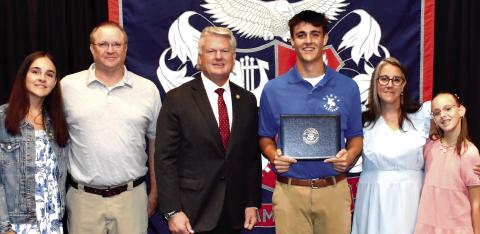 District 10 Congressman Mike Collins (center) with Putnam County High School senior Tanner Lukens and his family last Friday, during Lukens’ signing ceremony to begin attending the U.S. Merchant Marine Academy this fall. IAN TOCHER/Staff
