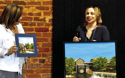 Victoria Anadenko (with microphone) spoke about her choice of photo during the Sept. 12 Dual Vision Exhibit hosted by the Artisans Village Art Gallery. CONTRIBUTED
