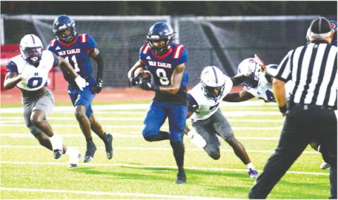 Kaleb Crawford (9) runs past Jasper County defenders in Friday’s 24-17 win. IAN TOCHER/Staff