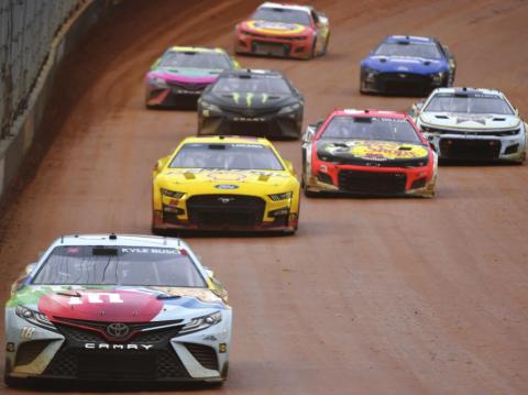 Winner Kyle Busch, driver of the #18 Mars Crunchy Cookie Toyota, drives during the Cup Series Food City Dirt Race at Bristol Motor Speedway Sunday night. (Logan Riely/Getty Images)