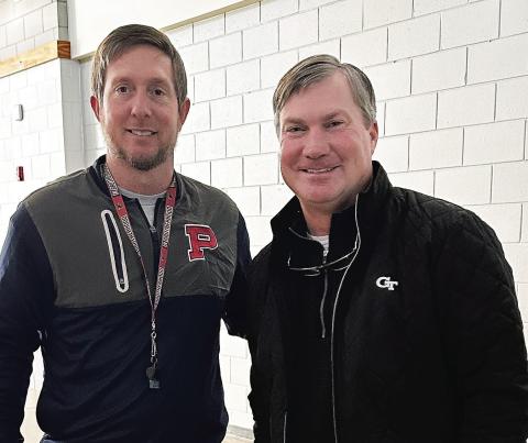 Putnam County head football coach Joel Harvin (left) is joined by Georgia Tech assistant coach Brian Bohannon in a recent visit to the school. CONTRIBUTED