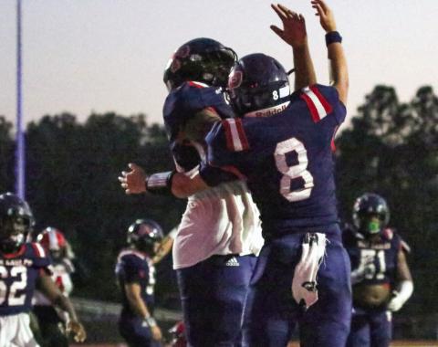 Putnam County quarterback Branan Griffin (8) celebrates with a teammate after scoring a touchdown in Friday’s 45-37 region win over McNair. LANCE McCURLEY/Staff