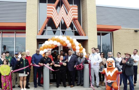 Taylor Borders and her daughter, Autumn (far left), were the first in line on the sidewalk at Whataburger for the ribboncutting ceremony, which earned Borders free weekly Whataburger meals for a year. IAN TOCHER/Staff