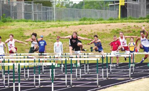 Ben Paxson of Gatewood competes with six other athletes in the 100 meter hurdles. T. MICHAEL STONE/Staff