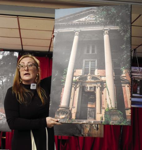 Seeking Asylum photographer Jessica Whitehead holds a picture of the Jones Building as she explains her journey with photography and Central State Hospital’s history. BAILEY MCCULLY/Staff