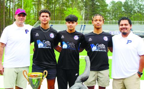 Putnam County head coach Michael Taylor (far left) poses with seniors (from left to right) Brad Reeves, Edwith Lopez and Marco Owensby, with assistant coach Jared Coronado (far right), after the players signed scholarships to play at the collegiate level. ARELLA CASH/Staff