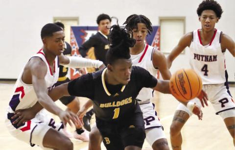 Strong defense against Zy’Quan Grant of Butler came from Putnam’s Eren Banks (left), Keyni Crawford (4) and Payton Ellison (0). ARELLA CASH/Staff
