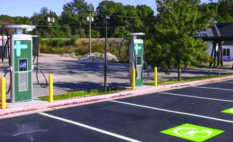 With downtown Eatonton’s historic train trestle and Ebeneezer Baptist Church in the background, brand-new EV charging stations installed alongside Willie Bailey Drive await final approval and activation through Georgia Power, expected to come within the next month. IAN TOCHER/Staff