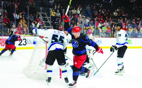 Garret Milan (center) of the Rock Lobsters celebrates after scoring on Mississippi goalie Edward Coffey in the first period of the two teams’ New Year’s Eve game at Akins Ford Arena in Athens. IAN TOCHER/Staff