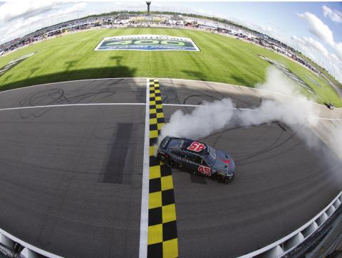 Kurt Busch, driver of the #45 Jordan Brand Toyota, celebrates with a burnout after winning the Cup Series AdventHealth 400 at Kansas Speedway Sunday. (Sean Gardner/Getty Images)