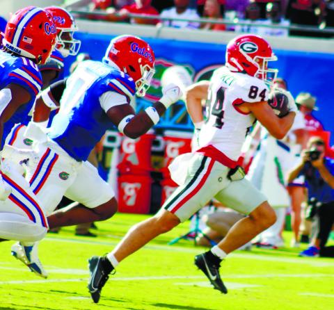 Georgia wide receiver Ladd McConkey (84) runs away from Florida defenders for a 41-yard touchdown. LANCE McCURLEY/Staff