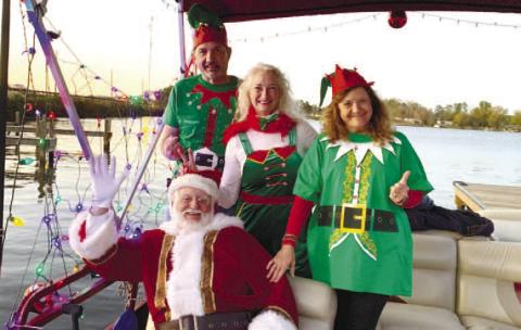Santa and his elves pose on their cruise ship before it takes off toward Christmas Cove. BAILEY BALLARD/Staff