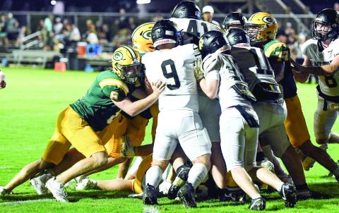 Gatewood quarterback Blake Brannen is somewhere in the middle of the crowd as he gets pushed across the goal line by teammates for the Gators’ lone score on Friday night. IAN TOCHER/Staff