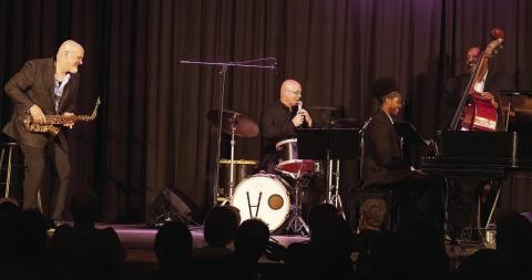 All smiles as drummer Justin Varnes of The Jazz Legacy Project describes the music of Charlie Parker to Festival Hall patrons.