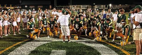 Early this season, Gatewood head coach Jeff Ratliff (center) held court with his players, cheerleaders, and parents of both near the 50-yard line at Sammons Field in Eatonton. IAN TOCHER/Staff