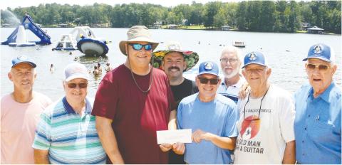 Masonic Home of Georgia Director of Home Life Chris Babcock (third from left) is surrounded by members of Eatonton's Rising Star Lodge #4 as they present a check destined to pay for things like extracurricular sports, prom clothes and transportation, or other school-related extras for the Home's current residents. IAN TOCHER/Staff