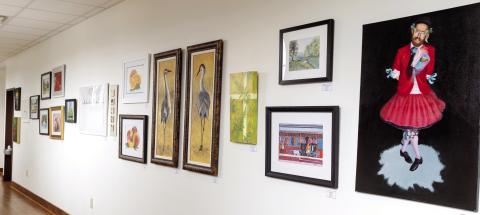 A variety of artwork hangs on the wall at Festival Hall in Greensboro and will remain on display for the next nine months. LEIGH LOFGREN/Staff