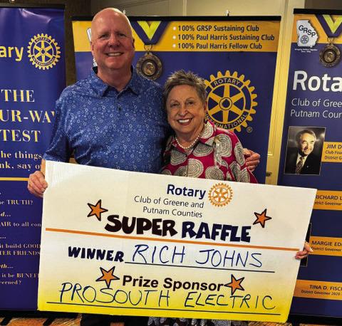 Rotary Raffle Week 38 winner Rich Johns accepted from Rotarian Micki Tanner his prize of a $300 Home Depot gift card, sponsored by ProSouth Electric. CONTRIBUTED