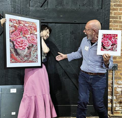 Artist Leslie Guo and photographer Lee Manis share a laugh over their contributions, both titled “Petite Roses.” CONTRIBUTED