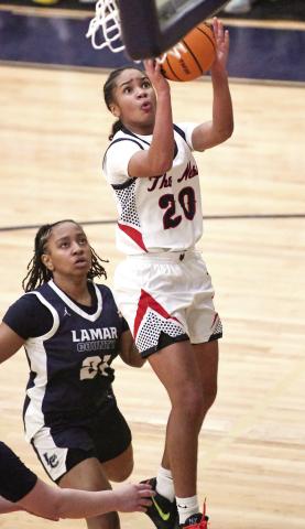 Putnam County freshman point guard Jaydah Baker (20) goes up for a layup over a Lamar County defender in a 70-56 win over the Lady Trojans on Jan. 28. Baker led the Lady War Eagles with 24 points in the win. IAN TOCHER/Staff