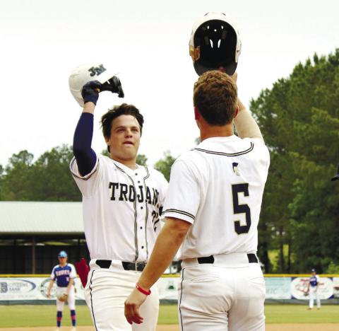 JMA’s Briggs Eady (5) celebrates with Brady Rollins (22) after hitting a home run last Friday against Heritage Academy. TREY NORRIS/Staff