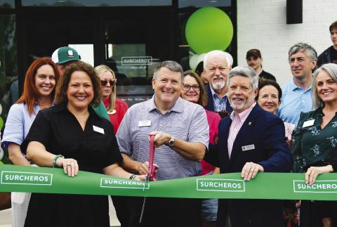 With his wife, Debbie, and Eatonton-Putnam Chamber of Commerce President Robbie King alongside, restaurateur Kyle Cullars prepare to cut the ribbon for his family’s third Surcheros franchise, with a fourth coming soon in Perry. IAN TOCHER/Staff