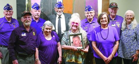 Members of the Athens-based John W. Hancock Memorial Chapter 531 of the Military Order of the Purple Heart pose with the daughter of Charlie Bonner Award for Advancing Education winner Richard “Ole” Olsen, holding a photo of her father. IAN TOCHER/Staff