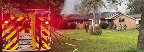 Smoke and flames can be seen on the back of the house as City of Eatonton and Putnam County firefighters begin to battle the blaze. CHIEF WILLIAMSON/Contributed