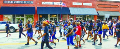 Carrying signs and wearing t-shirts emblazoned with Save Jimmy Davis Park, more than 200 people marched up Eatonton’s Jefferson Avenue.