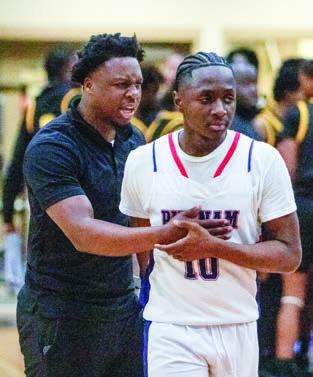 Putnam County assistant basketball coach Nick Banks (left) consoles junior guard Tamaud Woodson (right) after the team’s 68-66 loss to East Laurens in the Elite Eight last week. LANCE MCCURLEY/Staff