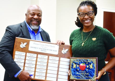 Putnam County Superintendent Derick Austin recognizes Putnam County Teacher of the Year Kenneshia Smith. BAILEY MCCULLY/Staff