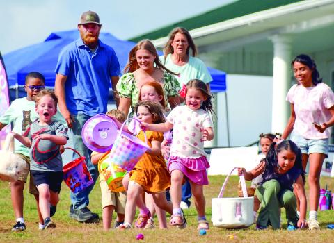 Families watch as children run to find Easter eggs. IAN TOCHER/Staff