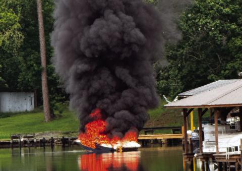 A boat adrift on Lake Sinclair is fully engulfed Friday morning before Putnam County firefighters arrive. CONTRIBUTED