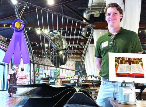 Inspired by an open-book photo of a Bible (right), Brian Danson created an all-metal sculpture featuring a pair of disembodied hands playing a harp that inspired a vote for him as the event’s Peoples’ Choice-winning artist. CONTRIBUTED