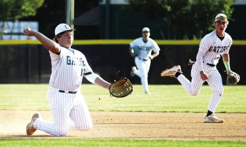 Gatewood’s Jayden Moss makes a play in the infield from his knees, attempting to throw out a baserunner at first base. TREY NORRIS/Staff