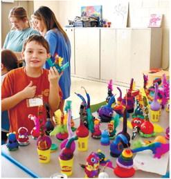 Liam Moon shows off his colorfully decorated gourd. LENA HENSLEY/Staff