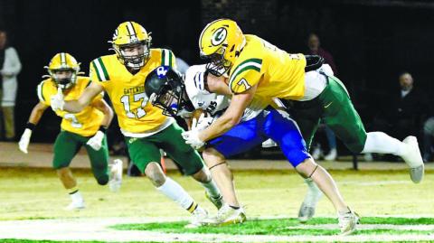 Gatewood defenders Sean Harvey (17) and Evan Bennett (7) converge on a Piedmont Academy ball carrier Oct. 28, with Ben Brannen (2) ready to join in if necessary at Sammons Field in Eatonton. DAWN SINCLAIR/Contributed