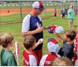 Former Braves pitcher Kevin Millwood signed hats, bats, and balls for several “Fisch campers” last August at the Greene County Recreation Center. Contributed