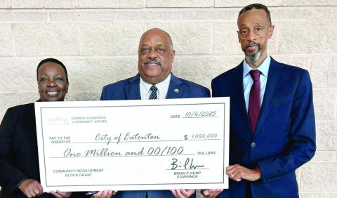 Eatonton Mayor John Reid (center) was joined by his wife and City Councilmember for Ward 3 Janie Reid, and Ward 2 Councilmember James Gorley in accepting a $1 million Community Development Block Grant for flood mitigation work on the south side of the city. CONTRIBUTED