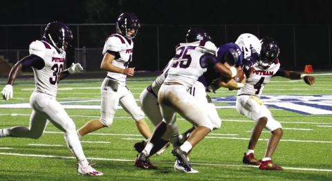 A pack of War Eagle defenders tackle Oconee County’s Jake Johnson during a scrimmage last season. LANCE McCURLEY/File Photo