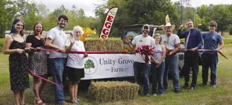 Unity Grove Farm owners Andrea Perkins (fourth from left) and Elliott Perkins (in cowboy hat), welcomed just a few friends and family members to a ribbon cutting last Saturday, hosted by the Eatonton-Putnam Chamber of Commerce.
