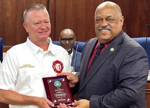 Joey “Superman” Davis (left) receives his retirement plaque from Eatonton Mayor John Reid. CONTRIBUTED