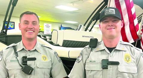 Georgia DNR Game Wardens Taylor Bingham (left) and Mason Miller conducted a safe boater class last month at Crowe Marine in Putnam County. (IAN TOCHER/Staff)