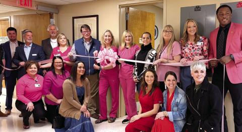 Putnam General Hospital staff and local officials, including Putnam County Clerk of Courts Trevor Addison (far left) and Eatonton-Putnam Chamber of Commerce CEO Robbie King, with Putnam General CEO Alan Horton (second and third from left, respectively), join office and medical staff members in celebrating the installation of a high-tech mammography machine at the Eatonton-based medical center. SKYLA MORRIS/Staff