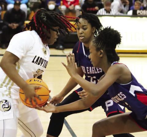 Kamyra Akins (21) and Kadyn Dennis (13) contributed to a strong defensive night for the Lady Eagles.