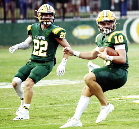 Gatwood's Hunter Johnson (22) and quarterback Ames Johnson (10, no relation) combined for a pair of touchdowns Friday night in a 40-0 rout of the visiting Lions from Loganville  Christian Academy. (IAN TOCHER/Staff)