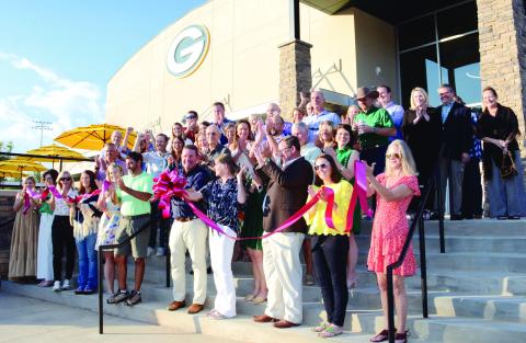 Head of Gatewood Schools Jeff Decker (center with bow) made the cut to officially open Gatewood’s new high school, though the building has been in use since school resumed early last month. (IAN TOCHER/Staff)