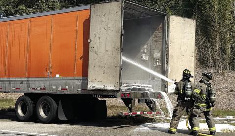 Putnam County firefighters extinguish a fire inside a truck trailer Monday on U.S. Hwy. 441. CONTRIBUTED/ PCFD